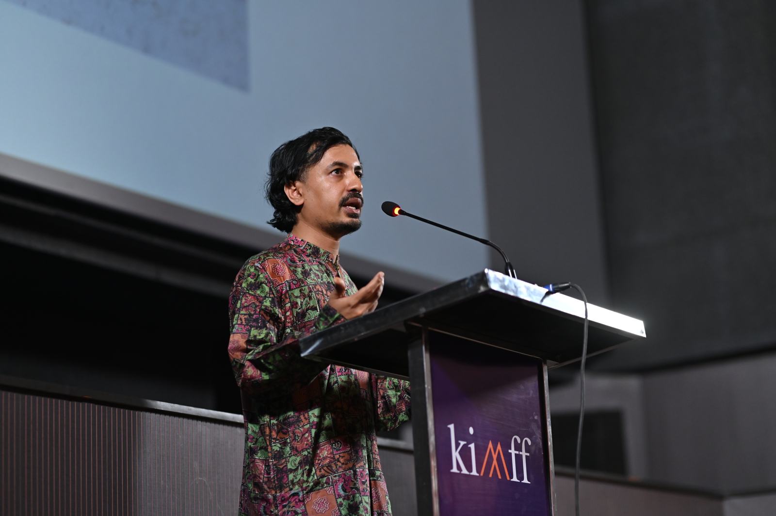A filmmaker pitches at the 2025 live pitch